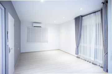 Empty room or bedroom in perspective at night. Interior inside house building with wooden floor or laminate, downlight, air conditioner, adjusting vertical, eyelet curtains. Look modern for background