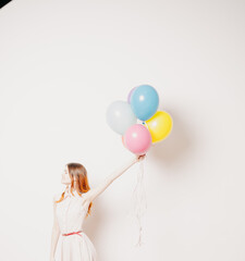 Fototapeta na wymiar cheerful woman in a dress of colorful balloons