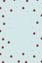 Christmas red balls, white snow baubles decorations on light blue background. Christmas composition.