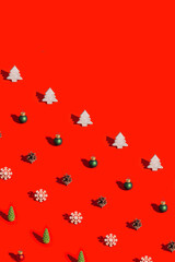 Bright Christmas pattern with natural decorations, wooden toys, pine cone with dark shadow on red