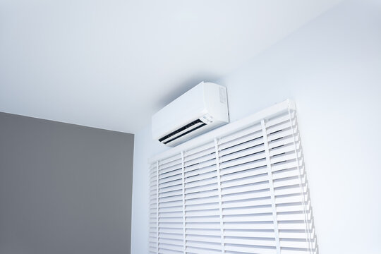 Air conditioner (ac) wall mount or indoor unit of split system for control climate, temperature and humidity. Include adjusting vertical or venetian blinds for adjust natural light to inside room.