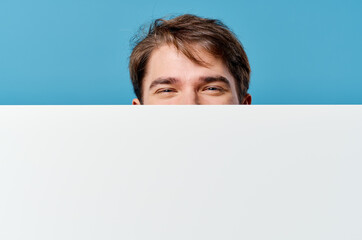 Cheerful man white sheet presentation advertising blue background