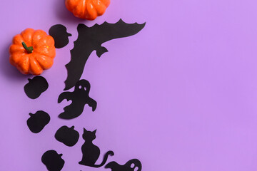 Halloween decor with pumpkins on violet background