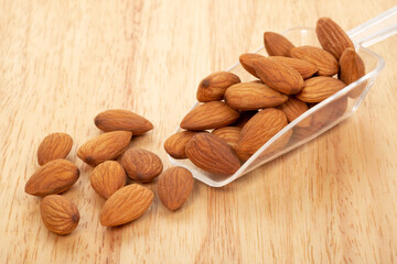 Almonds on wooden background. Healty food concept.