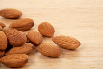 Almonds on wooden background. Healty food concept.