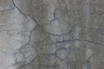 Old wall covered with cement. Beautiful wall with a lot of cracks 