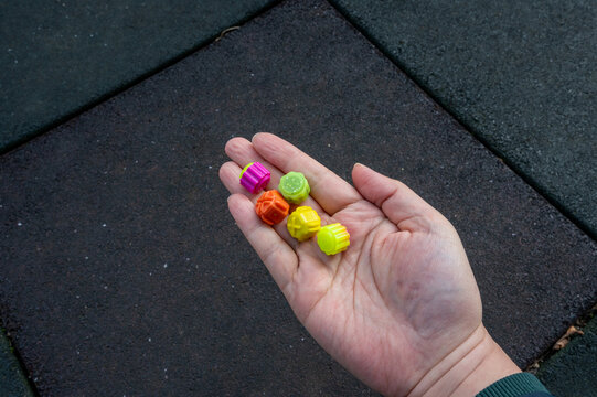 Male hand playing gonggitdol on playground