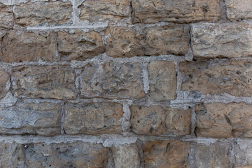 Wall surface of old gray-brown brick. Background. Space for text. Close-up.