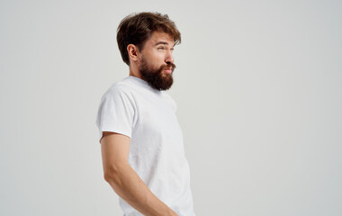 bearded man holding back arthritis health problems light background