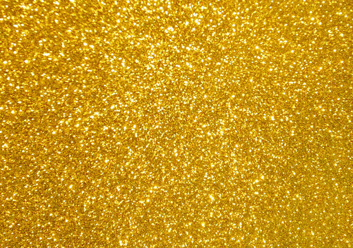 Golden yellow glitter bokeh background.  Photo can be used for New Year, Christmas and all celebration concepts.