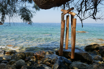 Bamboo wind chime hanging on a beach