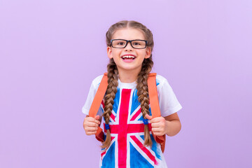 A schoolgirl with a briefcase and a painted flag of England on her T-shirt.