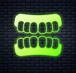 Glowing neon Dentures model icon isolated on brick wall background. Teeth of the upper jaw. Dental concept. Vector © Iryna