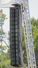 speakers hanging for an outdoor concert