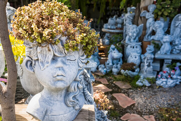 Fototapeta premium Bangkok, Thailand - August , 07, 2021 : Beautiful Stucco dolls decorate a beautiful garden in a garden supply store in Bangkok Thailand.