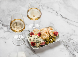 Delicious aperitif - appetizer plate with blue cheese, olives, homemade cheese cracker, figs  and...