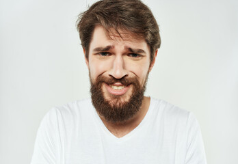 Obraz premium emotional man in a white t-shirt expressive look discontent Lifestyle