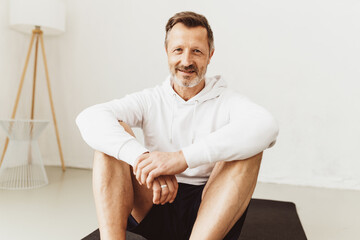 Attractive senior man relaxing after working out at home