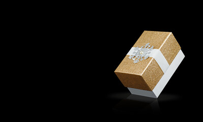 Golden gift box on black background with reflection.