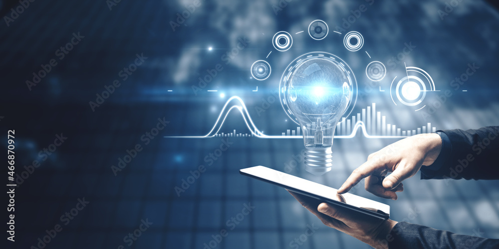 Aufkleber businessman using tablet with abstract glowing business interface with glowing light bulb on blurry 