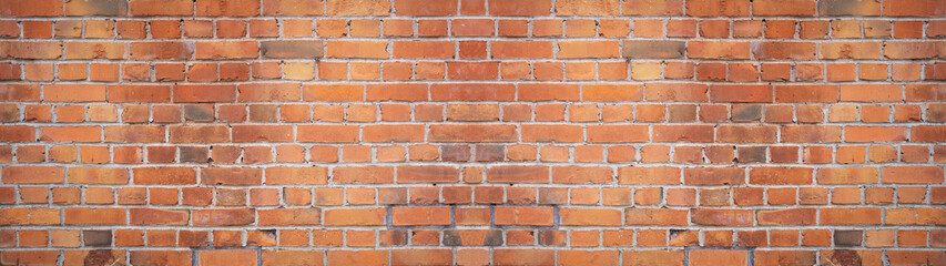 Orange red damaged rustic brick wall brickwork stonework masonry texture background banner panorama.