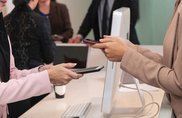 Closeup of woman making payment transaction with mobile phone.