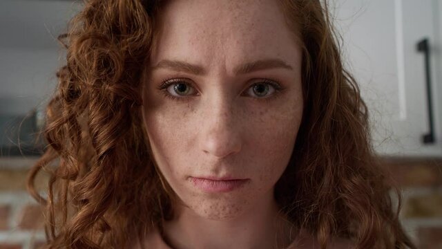 Close up of young caucasian woman with red curly hair. Shot with RED helium camera in 8K.