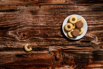 Flat lay decoration plate full of cookies on a wooden table