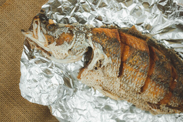 Crispy Thai style deep fried whole sea bass fish