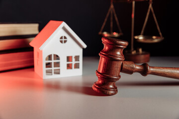 Sale of real property concept. Wooden model of house and gavel at notary office
