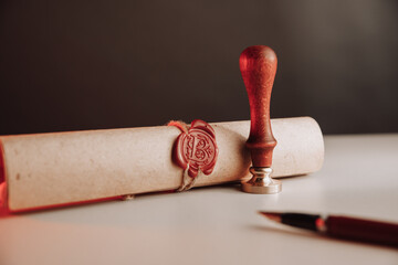 Scroll with wax seal stamp of notary public on a table. Law concept