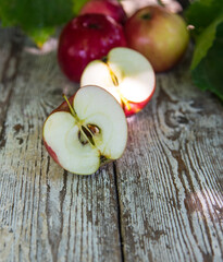 Red apple, with sliced water drops on an old table, close up, copy space, background