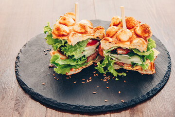 vegetarian waffles stuffed. Cheese, vegetables, tomato, cucumber, salad, greens, sauce, flaxseed.