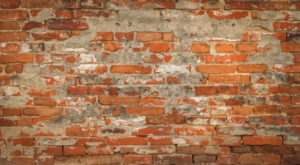 Old rustical brick wall with peeling plaster