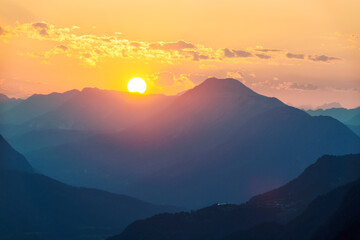 Sun setting behind mountains