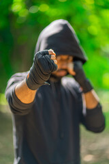 Young man doing boxing exercise outdoor