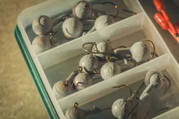 A set of fishing cargoes with hooks of different weights. Fishing box with accessories. Selective focus