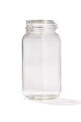 Detailed shot of a glass jar. Kitchen tableware is transparent. The jar with lid is isolated on the white background.