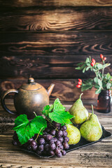 Still life of autumn fruits. Rustic background 