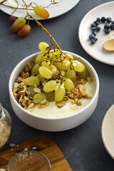 Granola breakfast with grapes and almond flakes
