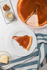 Cheesecake with caramel on gray cement background. Copy space for text.