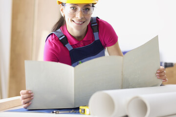Cute woman architect working with drawings