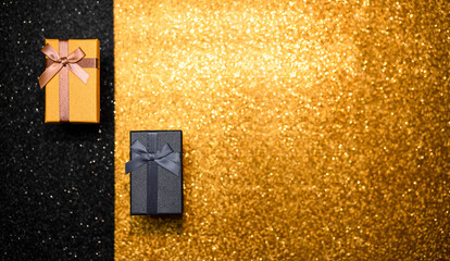 black and gold box on gold background with glitter. black friday.