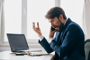businessmen in the office at the desk career anger official