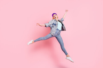 Full length photo of cool blond young lady jump wear jeans jacket visor isolated on pink background