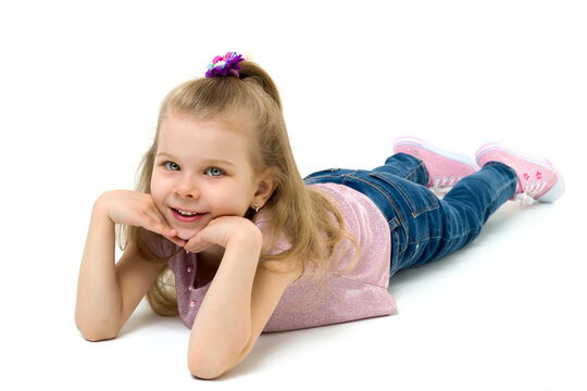 Charming girl lying on floor hands under her chin