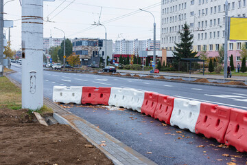 Red and white plastic road barriers. Construction props.