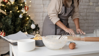 Smiling woman in the kitchen baking christmas cookies