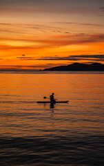 Sunset over wooden beach bar in sea and hut on pier in koh Mak island, Trat, Thailand
