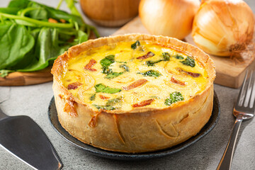 Spinach quiche with onion and bacon.